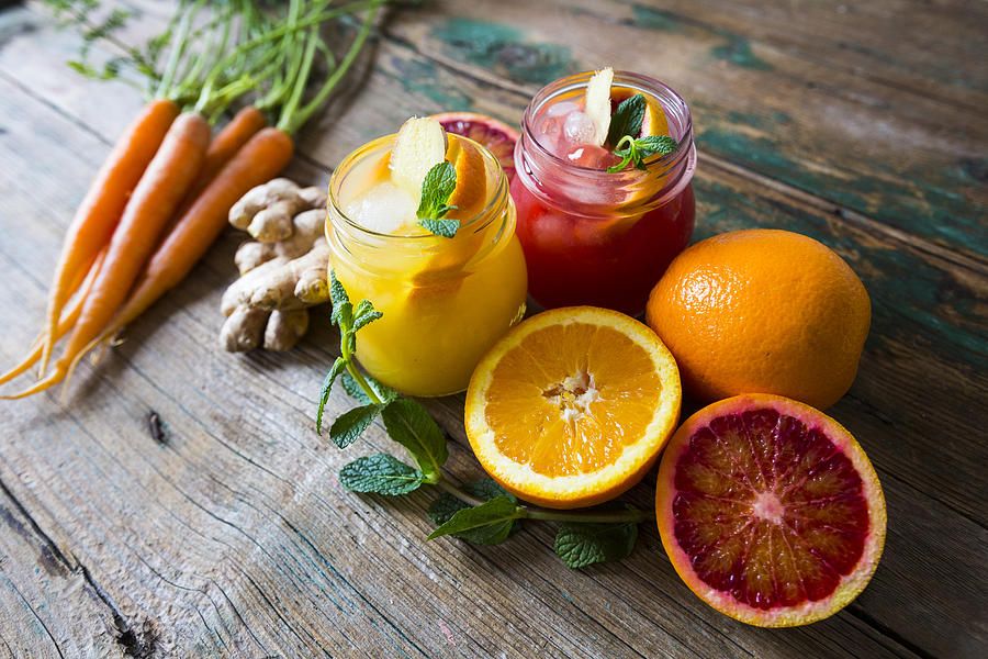 Juice with oranges and ginger and mint and carrots Photograph by Westend61