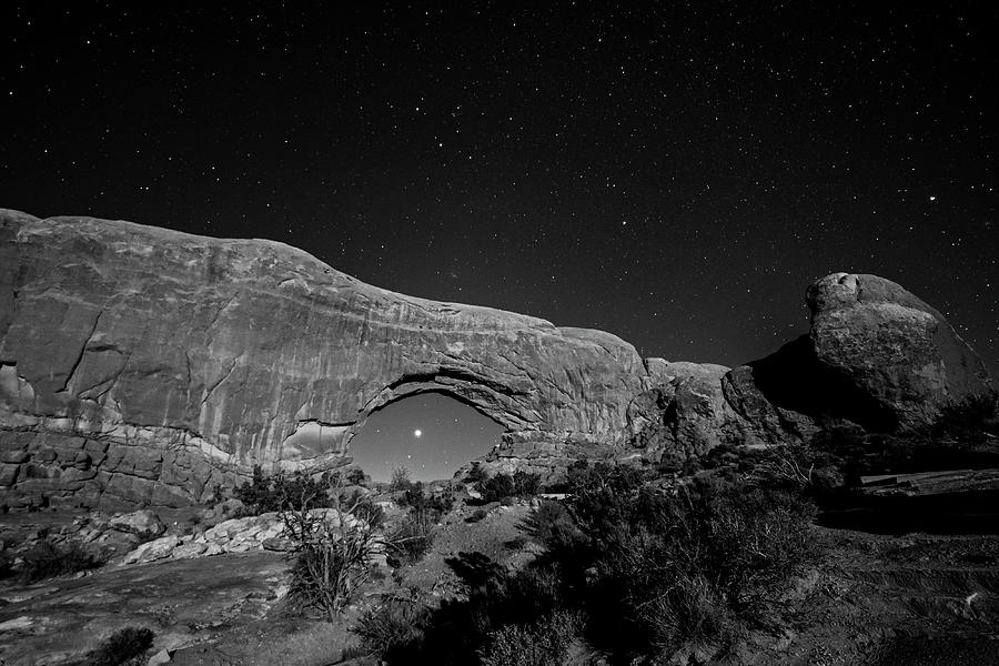 Jupiter and Saturn through the North Window in Arches National Park Moab Utah Black and White Photograph by Toby McGuire