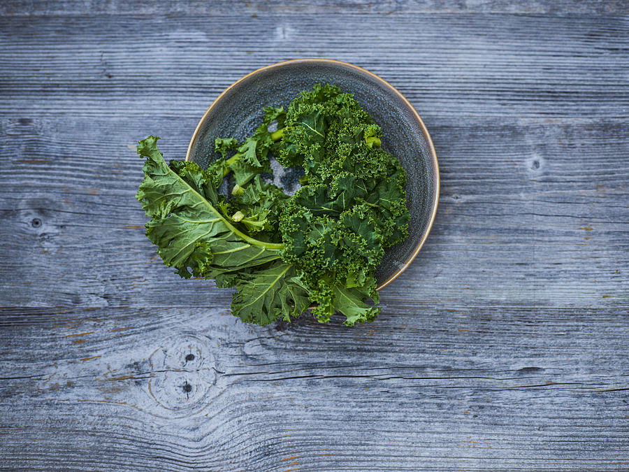 Kale leaves in bowl Photograph by Westend61