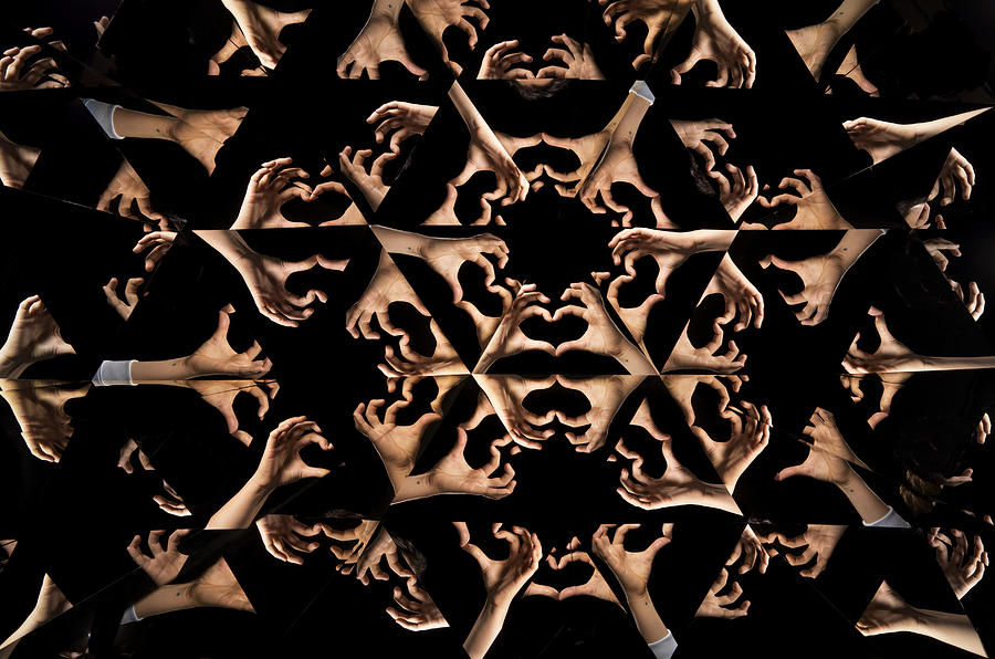 Kaleidoscope image of hands forming heart shape Photograph by Jonathan Knowles