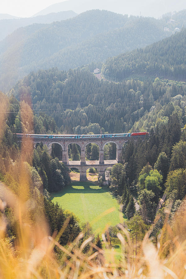 Kalte Rinne railway viaduct and a passing train in Semmering, Austria Photograph by Vaclav Sonnek