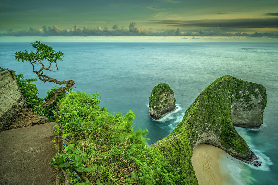 Kelingking beach on Nusa Penida in Bali, during a cloudy sunset. Photograph  by Anges Van der Logt - Fine Art America