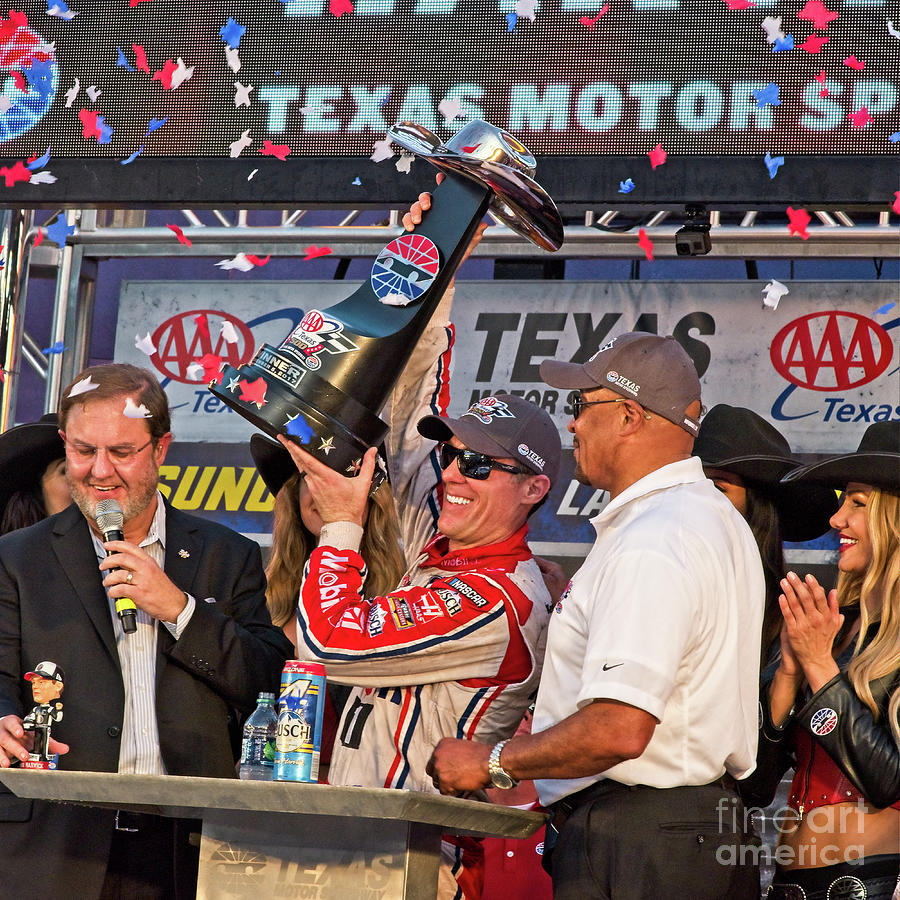 Kevin Harvick Lifitng His Tropy In The Winners Circle Photograph