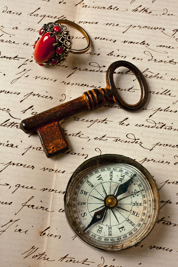 Key ring and compass on old letter Photograph by Garry Gay