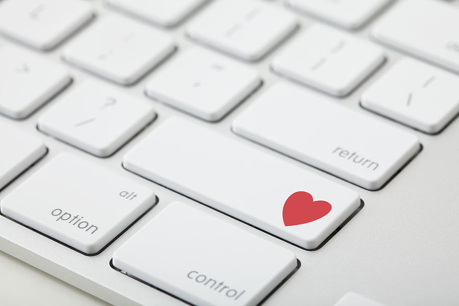Keyboard with red heart on button, close-up Photograph by Vstock