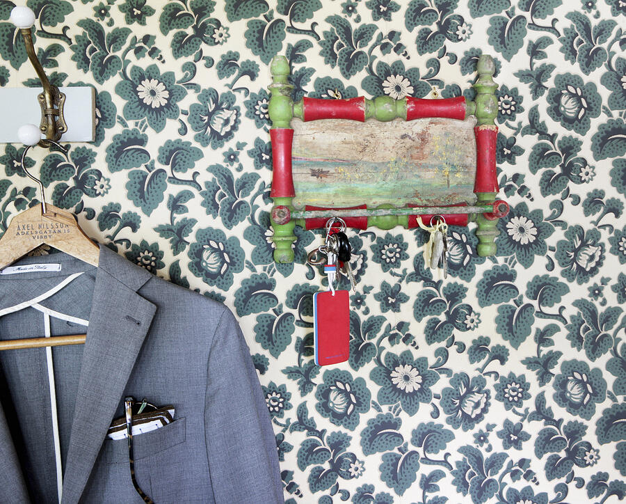 Keys hanger and jacket against floral wallpaper Photograph by Johner Images
