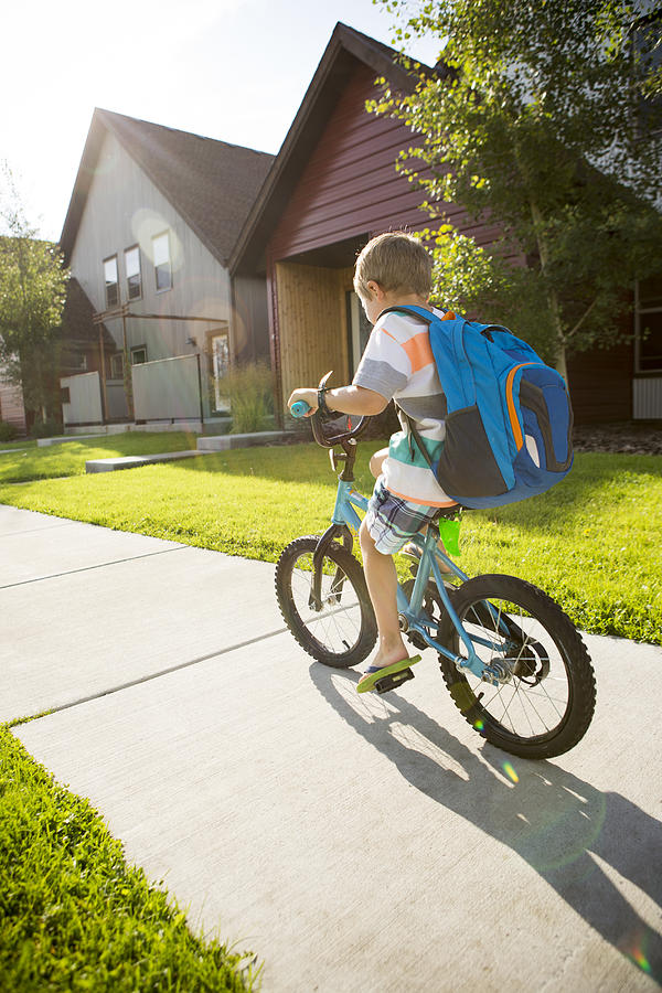 Kid biking to school. Photograph by Jordan Siemens