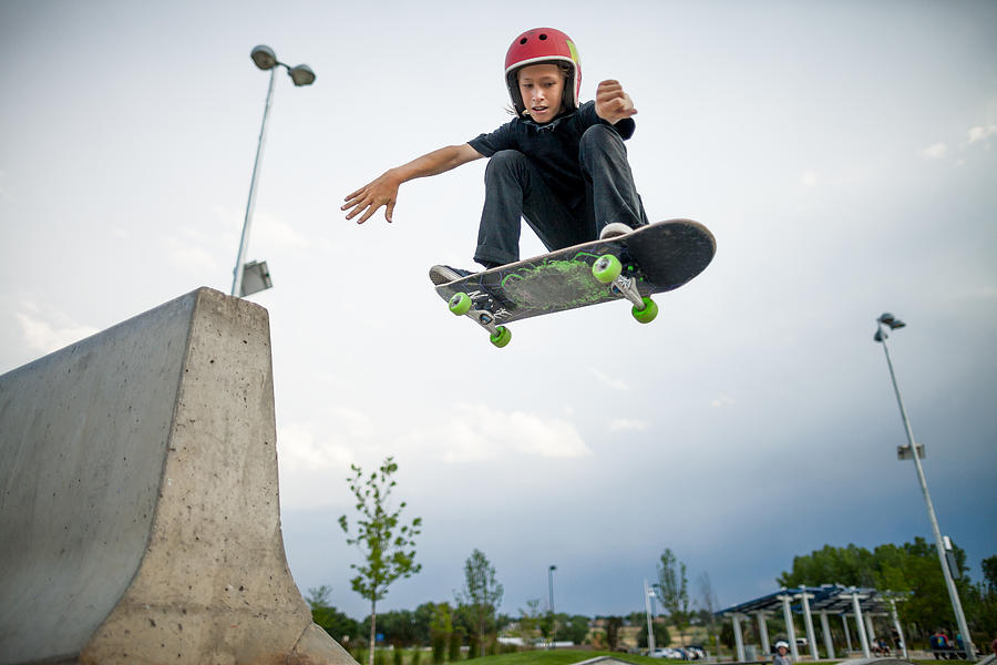 Kid, having fun skateboardin and jumping. Photograph by Daniel Milchev