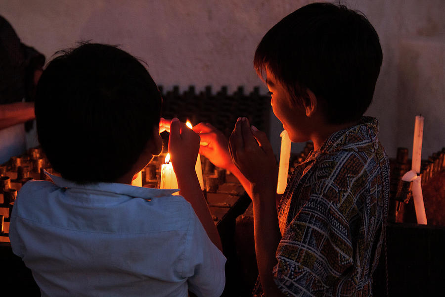 Kids lighting candles on Easter Day, Mexico Photograph by Tatiana Travelways