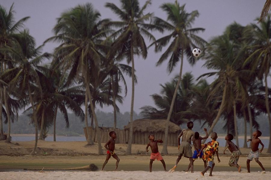 Kids playing beach football Photograph by Ben Radford