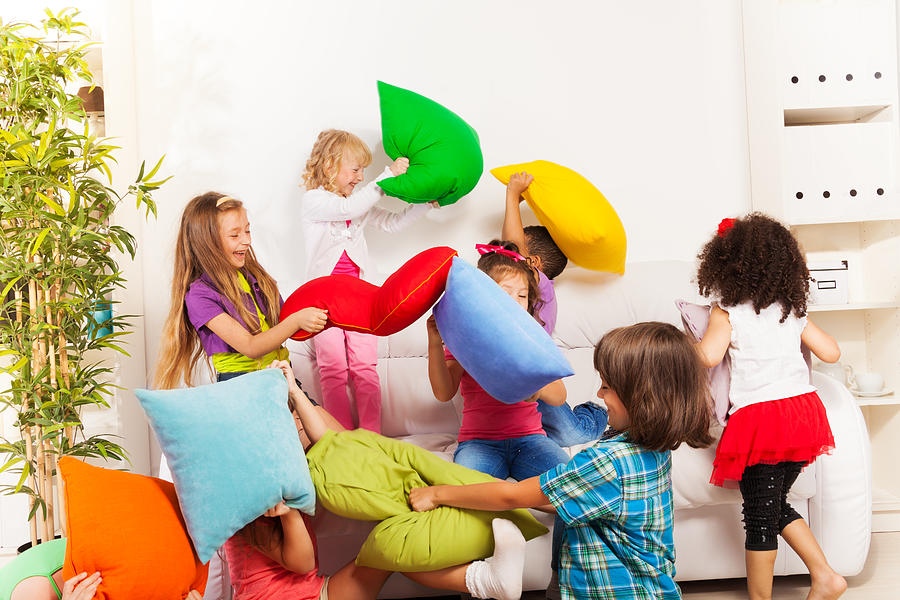 Kids playing pillow fight Photograph by SerrNovik