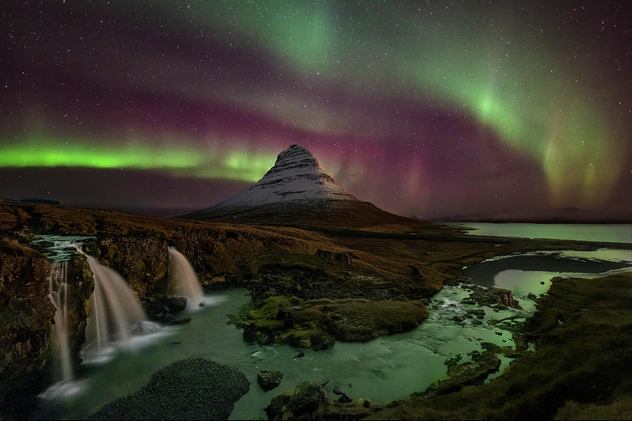 Kirkjufellsfoss Greets the Northern Lights Photograph by Roman Kurywczak