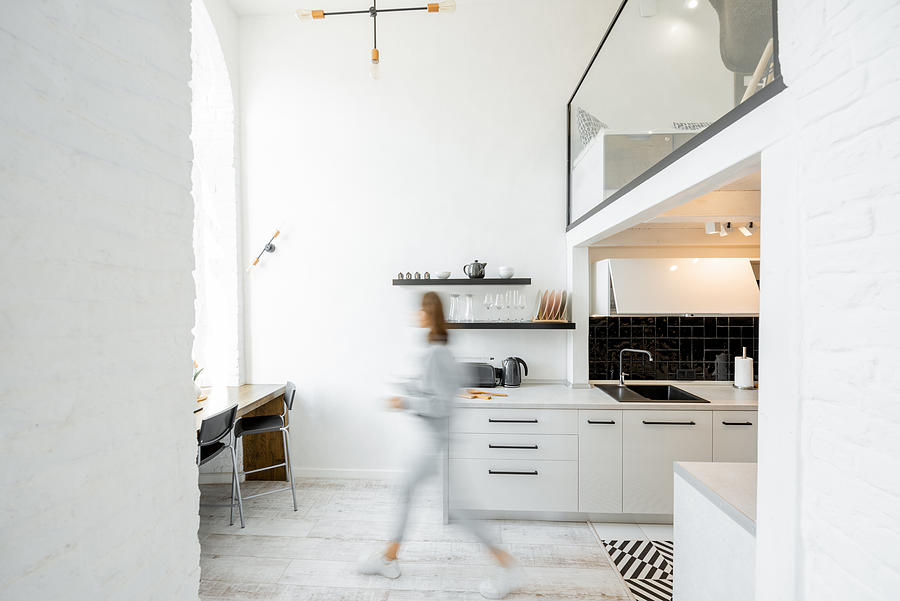 Kitchen with blurred human figure Photograph by RossHelen