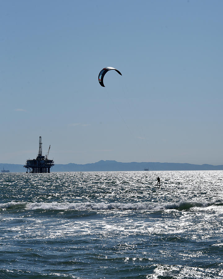 Kite Surfing near an offshore oil rig Photograph by Mark Stout