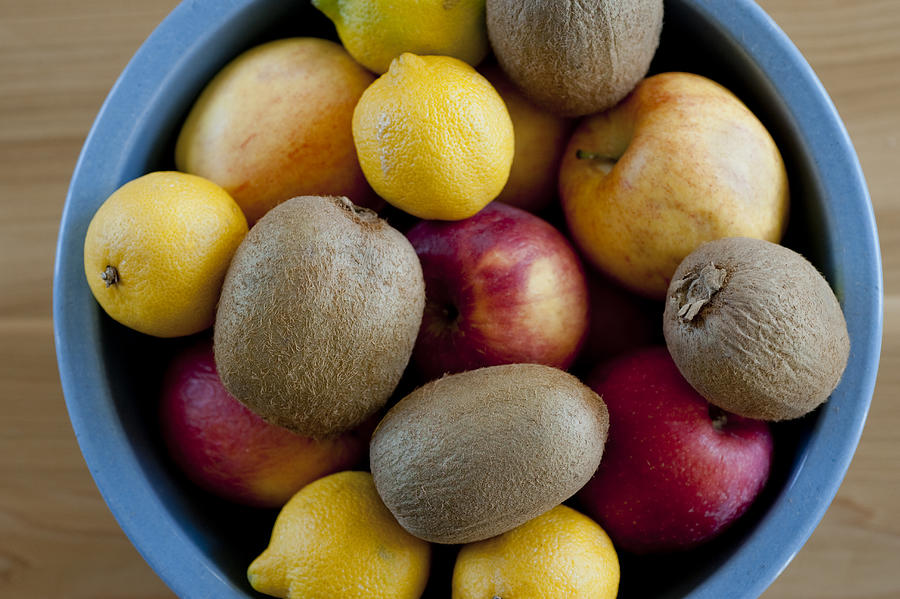 Kiwis, apples and lemons in a bowl Photograph by Thomas Winz
