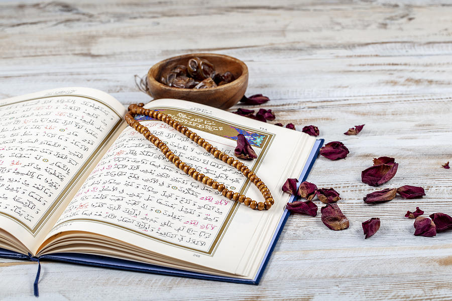 Koran - holy book of Muslims with rosary , date and dried flowers. ramadan concept Photograph by Asikkk