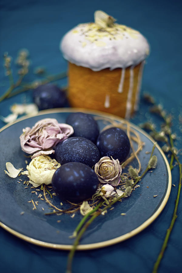 Kulich with sugar glaze .decoration design blue easter eggs lie on a ...