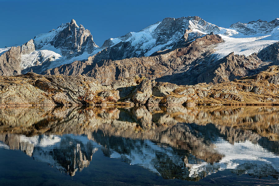 La Meije peak mirrored in Lake Lerie Photograph by Olivier Parent