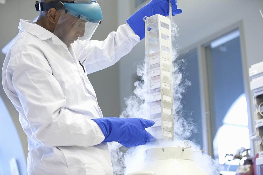 Lab technician pulls samples from liquid nitrogen Photograph by Assembly