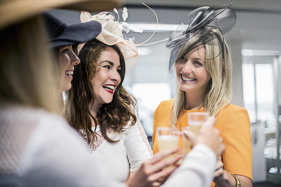 Ladies celebrating the Melbourne Cup in the offfice Photograph by Xavierarnau