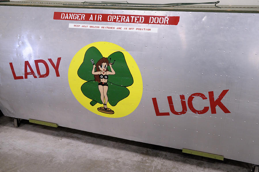 Lady Luck insignia on a bomber bay door Photograph by Kevin Oke