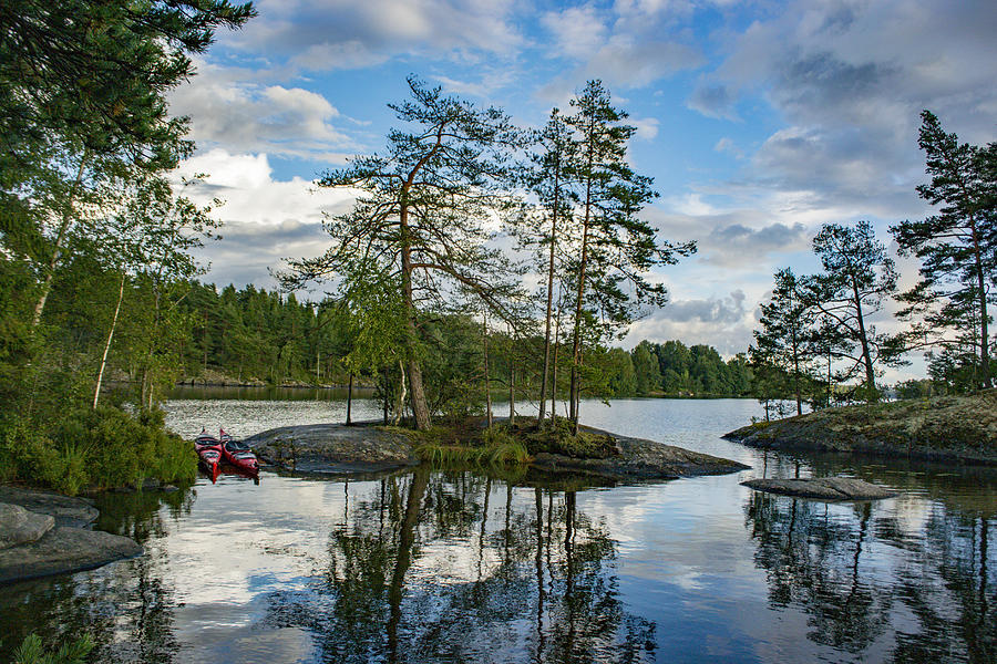 Lake with trees and rocks in the Dalsland Lake District in Sweden. Photograph by Sjo