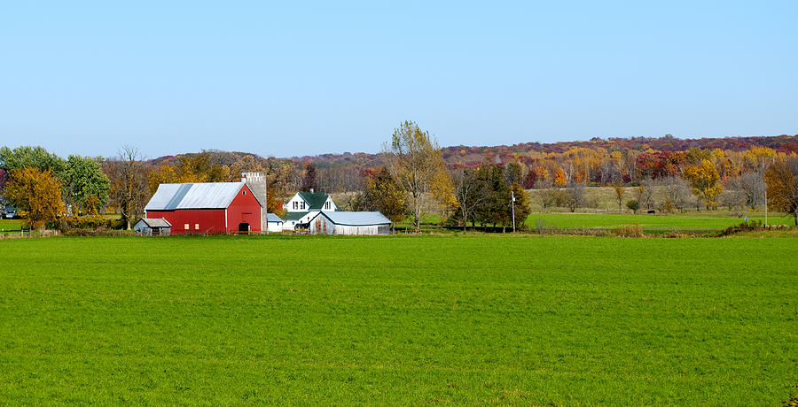 Landscape view of red Midwestern dairy farmhouse and land Photograph by JenniferPhotographyImaging