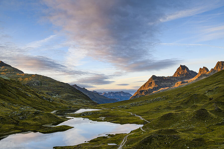 Landscape with mountains at a beautiful small lake at sunset Photograph by Kemter