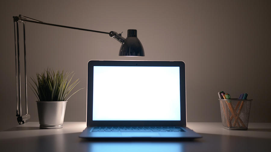Laptop with a White Screen on the Table at Night Photograph by Profstocktv