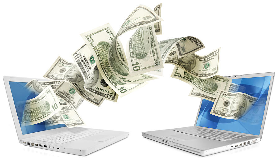 Laptops sending money Photograph by LdF