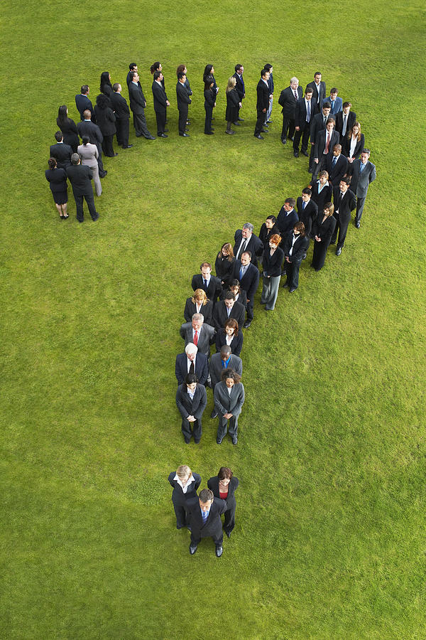 Large group of business people standing in question mark formation, elevated view Photograph by Moodboard
