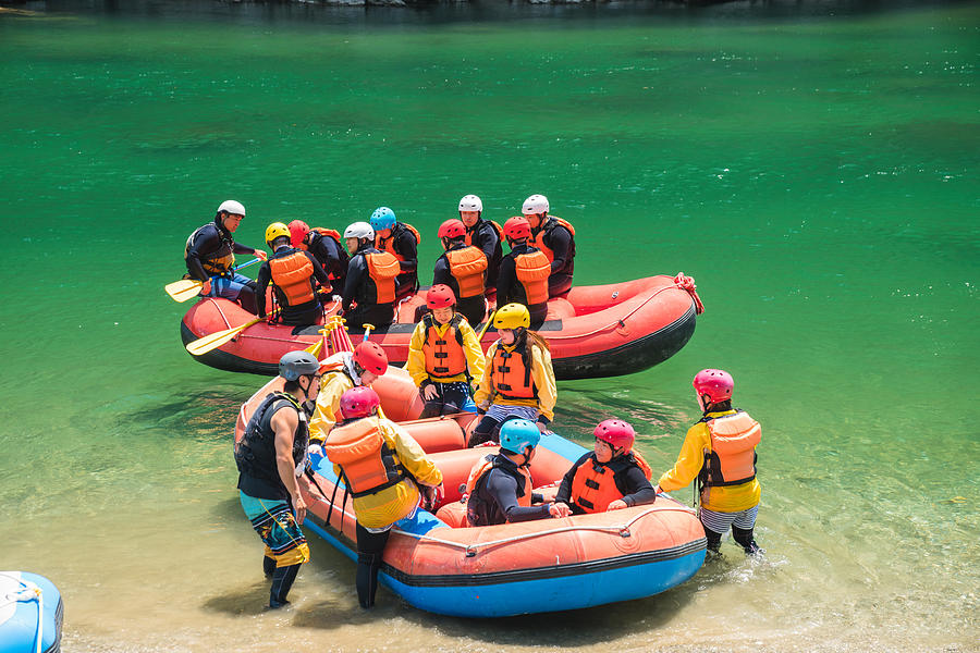 Large group of men and women boarding rafts to go white water river rafting Photograph by Tdub303