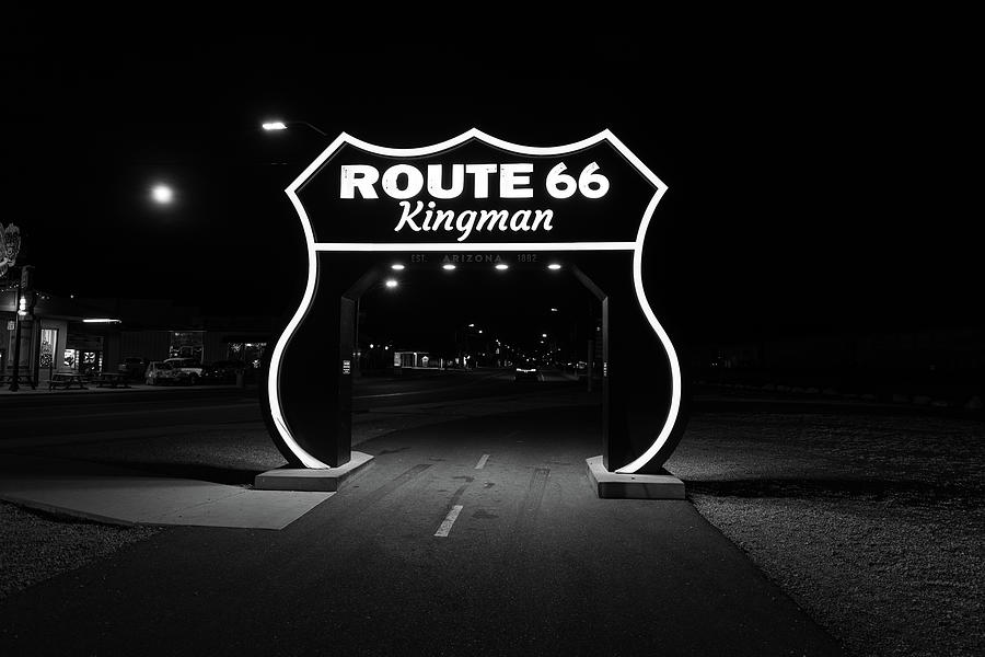 Large Route 66 sign in Kingman Arizona at night in black and white Photograph by Eldon McGraw