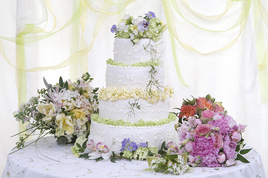 Large Wedding cake on table with flowers Photograph by Jonathansloane