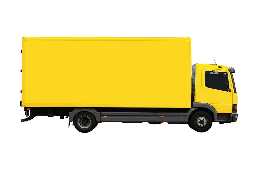 Large, yellow moving truck isolated Photograph by Macroworld