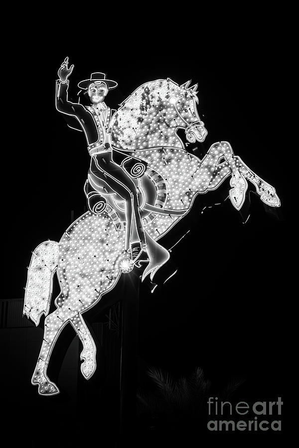 Las Vegas Photograph - Las Vegas Hacienda Hotel Horse and Rider Neon Sign Black and Whi by Paul Velgos