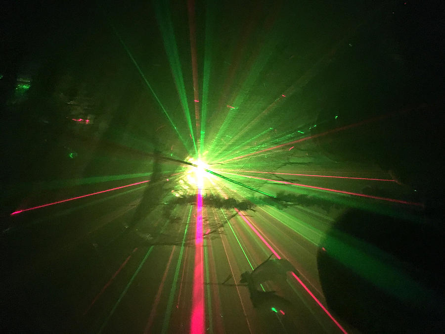 Laser light show in a dark room Photograph by Douglas Sacha