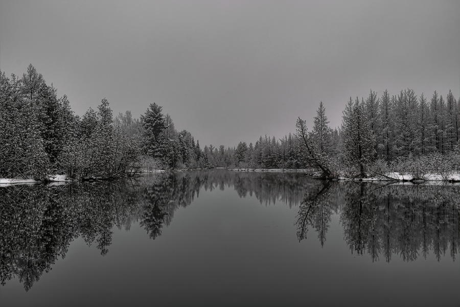 Late Season Snowfall On A Spring Fed Pond Photograph by Dale Kauzlaric