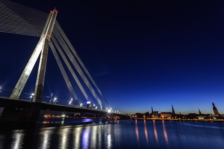Latvia, Riga, River Daugava, Illuminated Vansu Bridge reflecting in river Photograph by Henryk Sadura