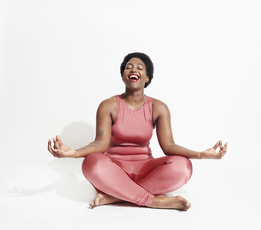 Laughing woman in lotus position Photograph by We Are
