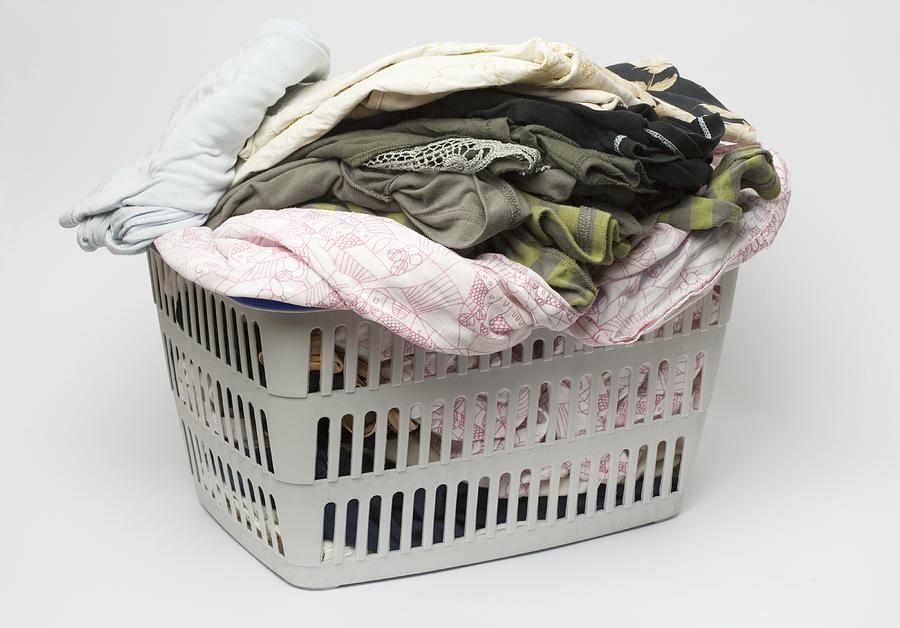 Laundry basket full of clothes Photograph by Ragnar Schmuck