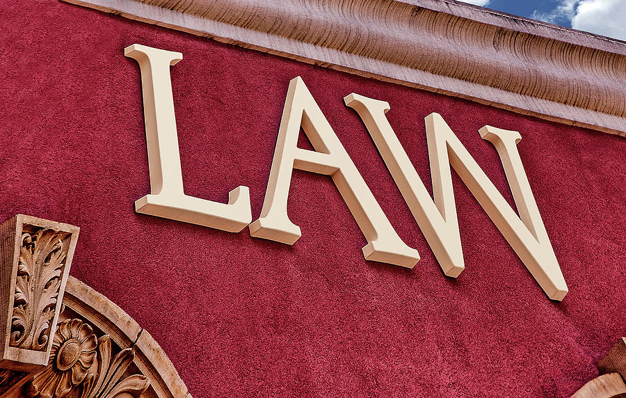 Law Sign on Crimson Red Stucco Wall Photograph by Phil Cardamone