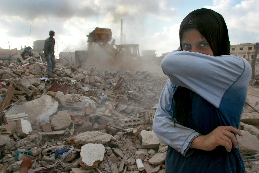 Lebanon, Sidiken, Girl in destroyed town covering mouth from ashes, portrait Photograph by Hans Neleman