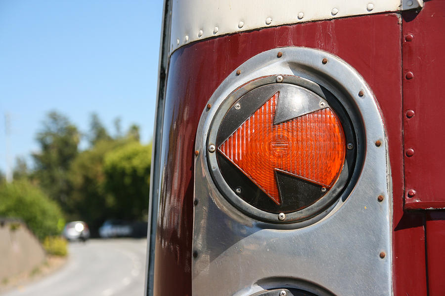 Left arrow-shaped tail light signal of red bus Photograph by Image by Marie LaFauci