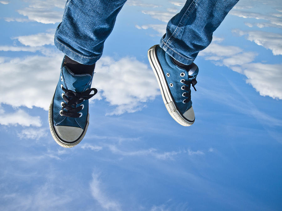 Legs and feet flying against a blue sky Photograph by Nick Page