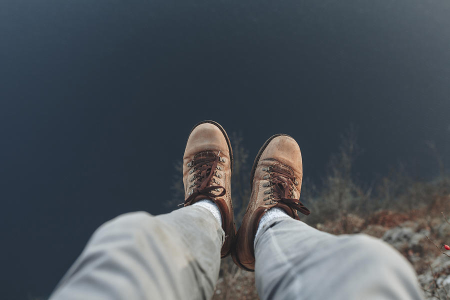 Legs of Caucasian man sitting at the edge of reservoir Photograph by Mykhailo Lukashuk