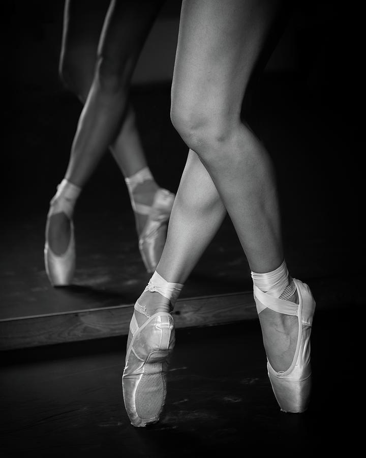 Legs of young ballerina with pointe shoes dancing. Ballet practice. Photograph by Michalakis Ppalis