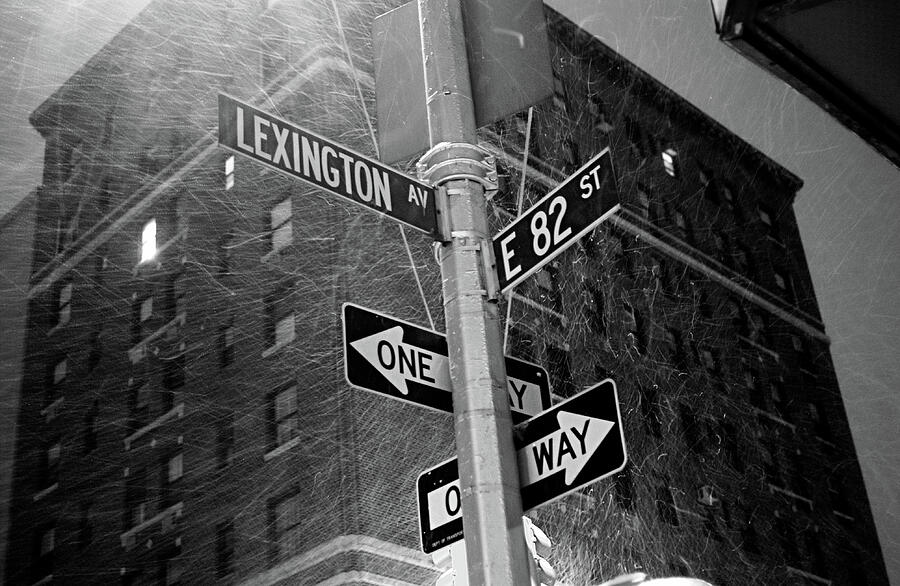 Lexington Ave and E82nd ST street sign in snowstorm black and white Photograph by David Smith