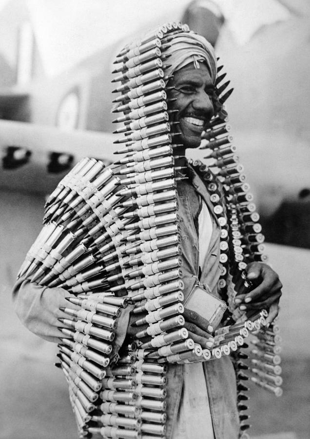 Libyan Assistant To An RAF Armourer Wearing Ammunition - WW2 - Circa 1941 Photograph by War Is Hell Store