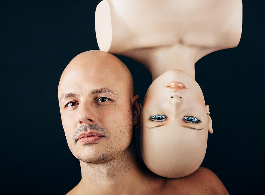 Lifestyle concept with bald man with upside down female mannequin Photograph by Drazen_
